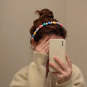 Colorful heart beads and pearls headband shown on model for a sweet aesthetic look