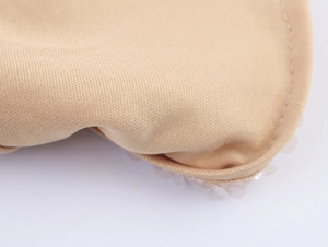Close-up of beige knitted fabric with fine stitching and anti-slip silicone dots