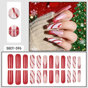 Christmas press-on nail kit with 24 long coffin nails featuring red snowflakes and candy stripes
