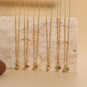 Artistic display of six 14K gold-plated necklaces with colorful zircon fruit pendants