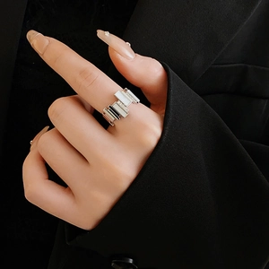 Macro detail of silver geometric ring with black and white inlay and pave zircons on hand