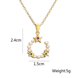 Detailed view of gold necklace pendant with colorful rhinestones and faux pearls