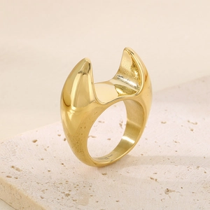 Detail view of bold 18K gold plated stainless steel chunky ring on stone display