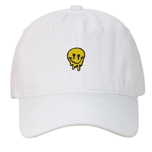 Detailed view of yellow melting smiley face embroidery on a white cotton baseball cap