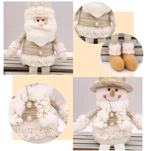 Detailed close-up of festive plush dolls with gold sequins and soft white faux fur textures