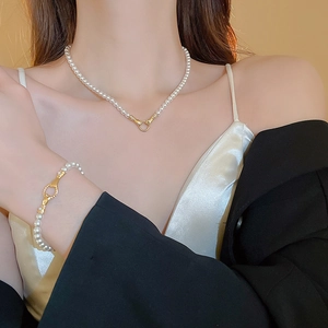 French style pearl necklace and bracelet set with gold ring clasp on model
