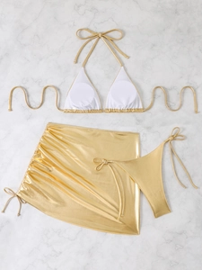 Detailed flat lay of golden metallic three-piece bikini set with drawstring mini skirt