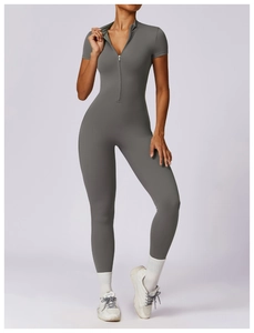 Close-up of a grey short sleeve yoga jumpsuit with a front zipper and slim-fit design