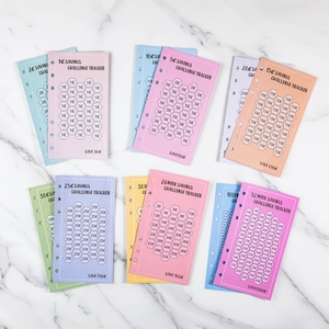 A6 6-hole savings challenge tracker cards for 52-week budget planning on marble background