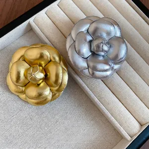 Minimalist leather camellia flower brooch set with gold and silver metallic petals