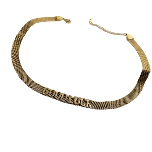 Collier ras du cou en maille dorée avec pendentif lettre GOODLUCK pour femme sur blanc