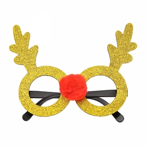 Close-up of gold glitter Christmas glasses with reindeer antlers and red pom-pom nose