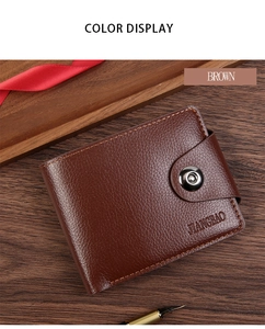 Close-up of brown litchi grain leather wallet with metal snap on a dark wood background