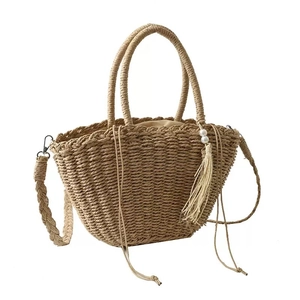 Handmade straw tote bag with ring handles, pearl charm, and woven shoulder strap