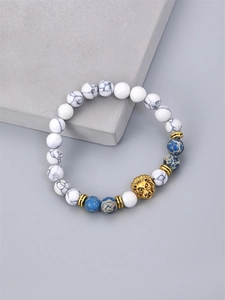 Men's beaded bracelet with white turquoise stone beads and a gold lion head charm