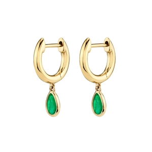Detail of gold huggie earrings featuring vibrant pear-cut green emerald gemstones