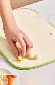 Close-up of cutting board with a built-in grinding area for garlic and ginger