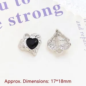 Macro shot of 17x18mm silver heart pendant with black gemstone and textured metal back