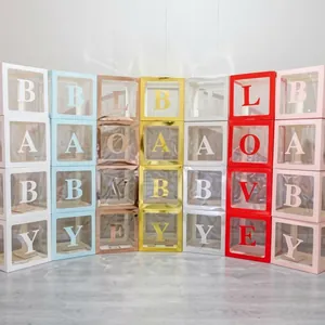 Vue détaillée de boîtes de fête transparentes colorées avec lettres BABY et LOVE brillantes