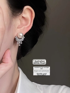 Detail of silver needle earrings with Australian white pearl and sparkling rhinestones