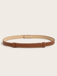 Detailed close-up of brown cross-grain leather belt with adjustable metal buckle detail