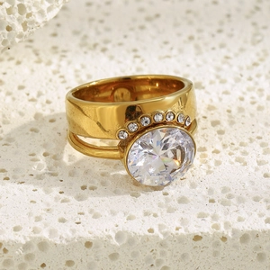Close-up of 18K gold-plated ring with two oval cubic zirconia on textured stone