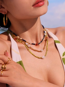 Close-up of bohemian multi-layer beaded necklace with pearls and colorful seed beads
