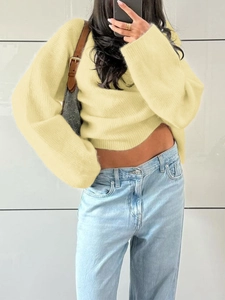 Detail of yellow knit sweater with soft texture and casual loose fit design for women