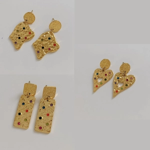 Three pairs of golden geometric heart earrings with colorful crystals and hammered texture