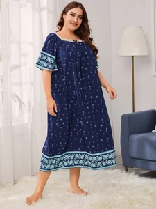 Detail view of navy blue floral nightgown with lace neckline and paisley printed hem