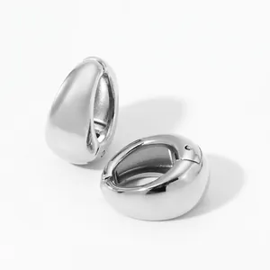 Detailed view of silver thick teardrop huggie earrings with a high-polished metal finish