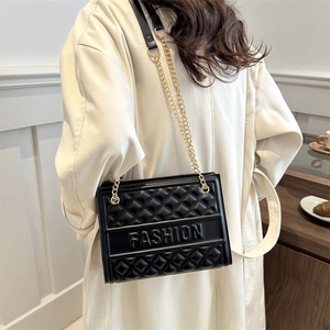 Black quilted shoulder bag with gold chain strap and embossed fashion lettering