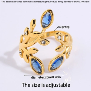 Macro shot of gold wheat leaf ring with blue gems and adjustable size details