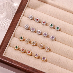 Elegant floral stud earrings set with colorful crystals in a premium jewelry display box