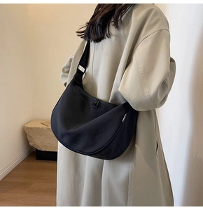 Detail of waterproof nylon dumpling bag with adjustable wide strap and zip closure