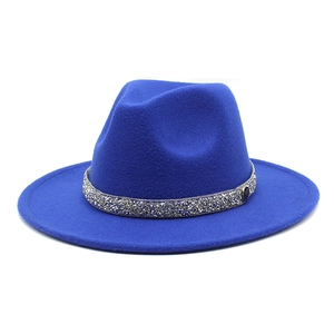 Detail of royal blue fedora with sparkling rhinestone band and small M logo charm