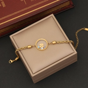 Detailed macro of golden Evil Eye charm bracelet with clover inside on jewelry box