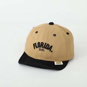 Close-up of FLORIDA embroidery and brand label on two-tone khaki and black baby cap