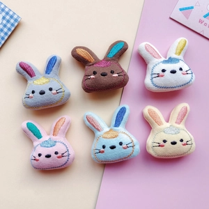 Detail of six colorful embroidered rabbit doll patches for DIY hair accessories and brooches