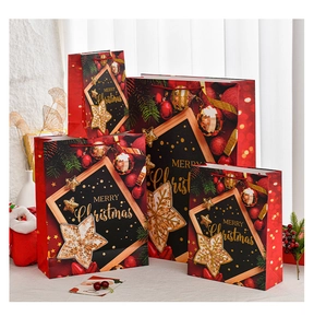 Macro detail of large red Christmas gift bags with gold foil and festive patterns