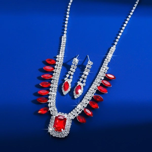 Detailed macro view of square red crystal necklace and earrings set with silver finish