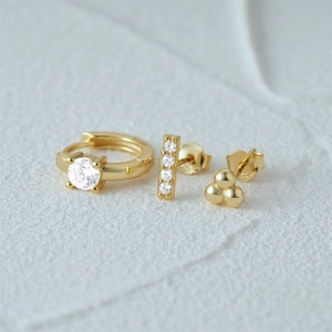 Macro detail of S925 sterling silver stamp on gold-plated three-piece earring set