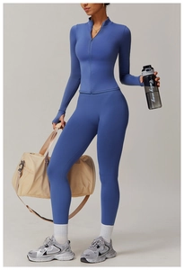 Detail of smog blue yoga set featuring thumb holes on sleeves and high waist leggings