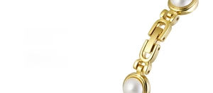 Macro shot of the golden jewelry clasp with inlaid white pearls for elegance