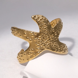 Minimalist 18k gold starfish open cuff bracelet with textured finish in marine style