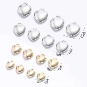 Detailed view of silver and gold heart-shaped CCB beads in four varying sizes for DIY