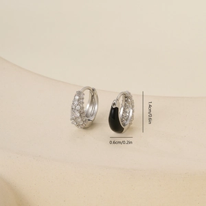Macro detail of cubic zirconia inlaid hoop earrings with black enamel and dimensions