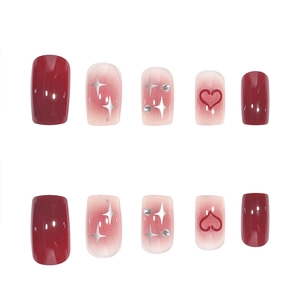 Deep red and pink gradient press-on nails with silver star patterns and rhinestones