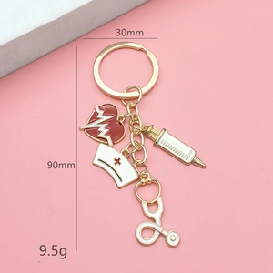Detail view of gold medical keychain showing dimensions 90mm length and 30mm ring diameter