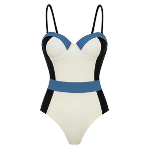 Detail of color-block one-piece swimsuit featuring blue and white geometric design